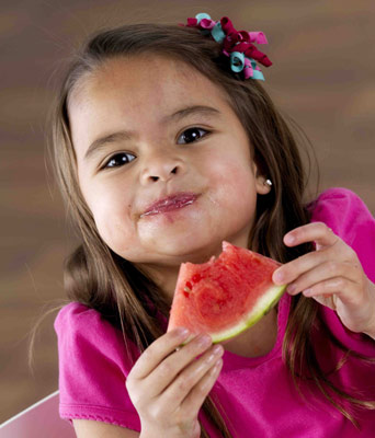 child eating watermelon