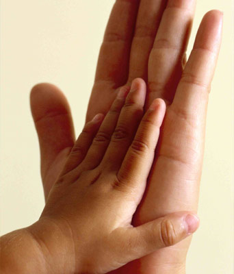 child and parents hand